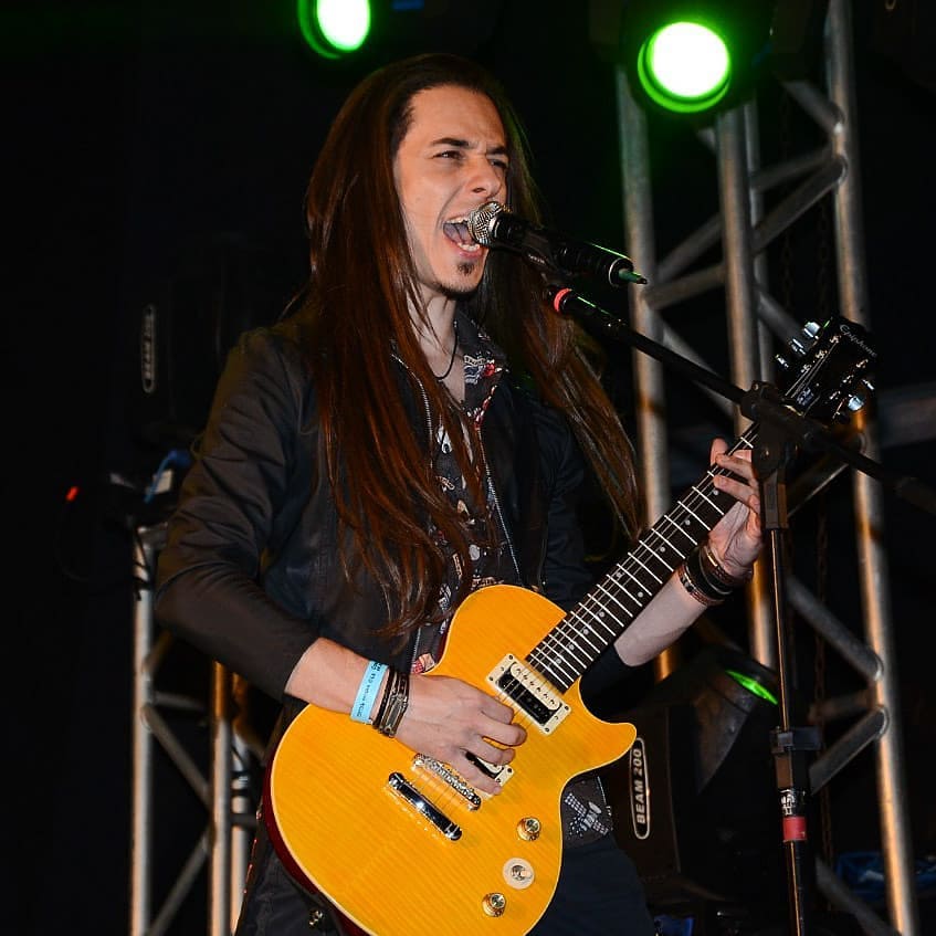 Murilo Campos tocando guitarra e cantando